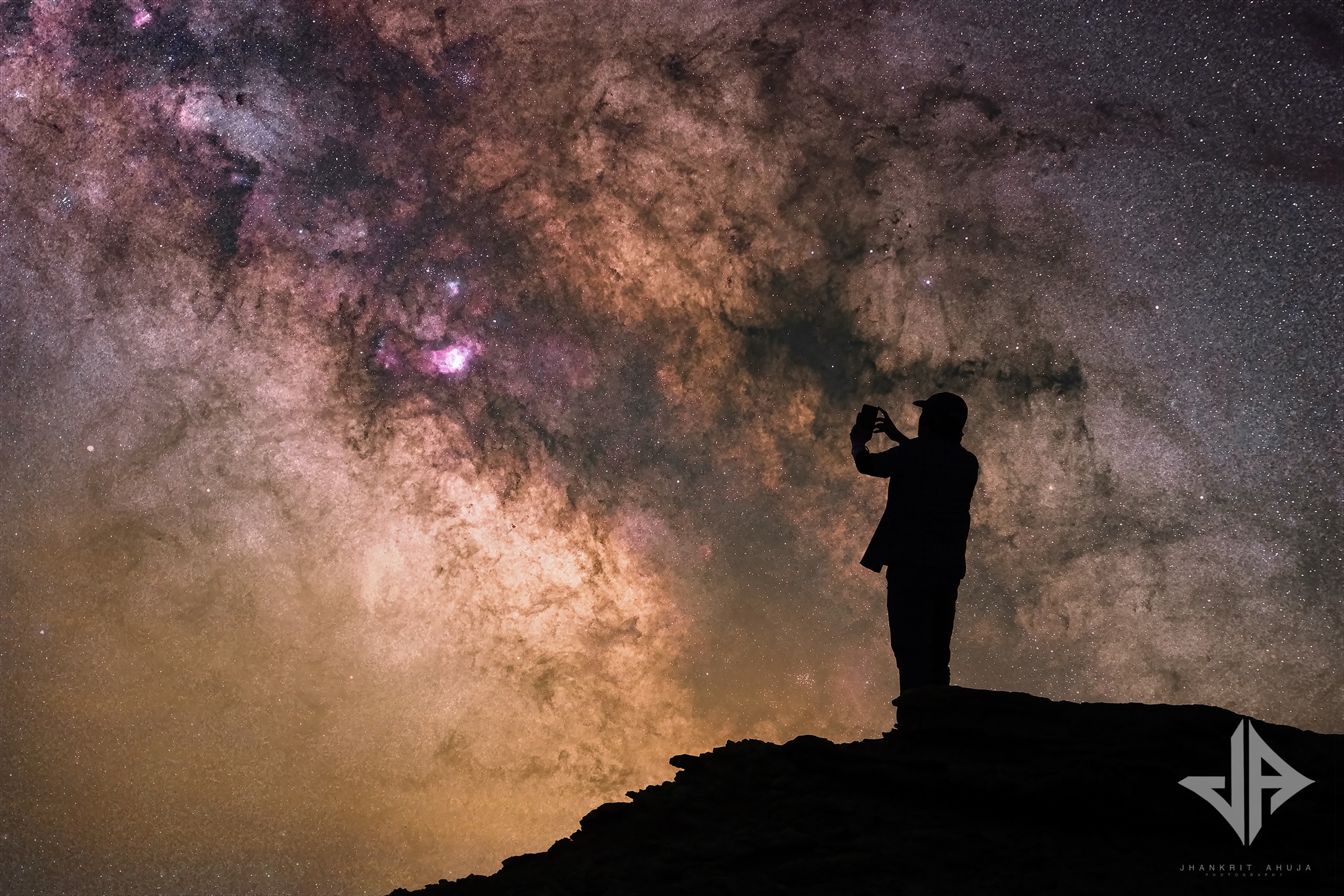 A photographer beneath the Milky Way core in the high Himalaya