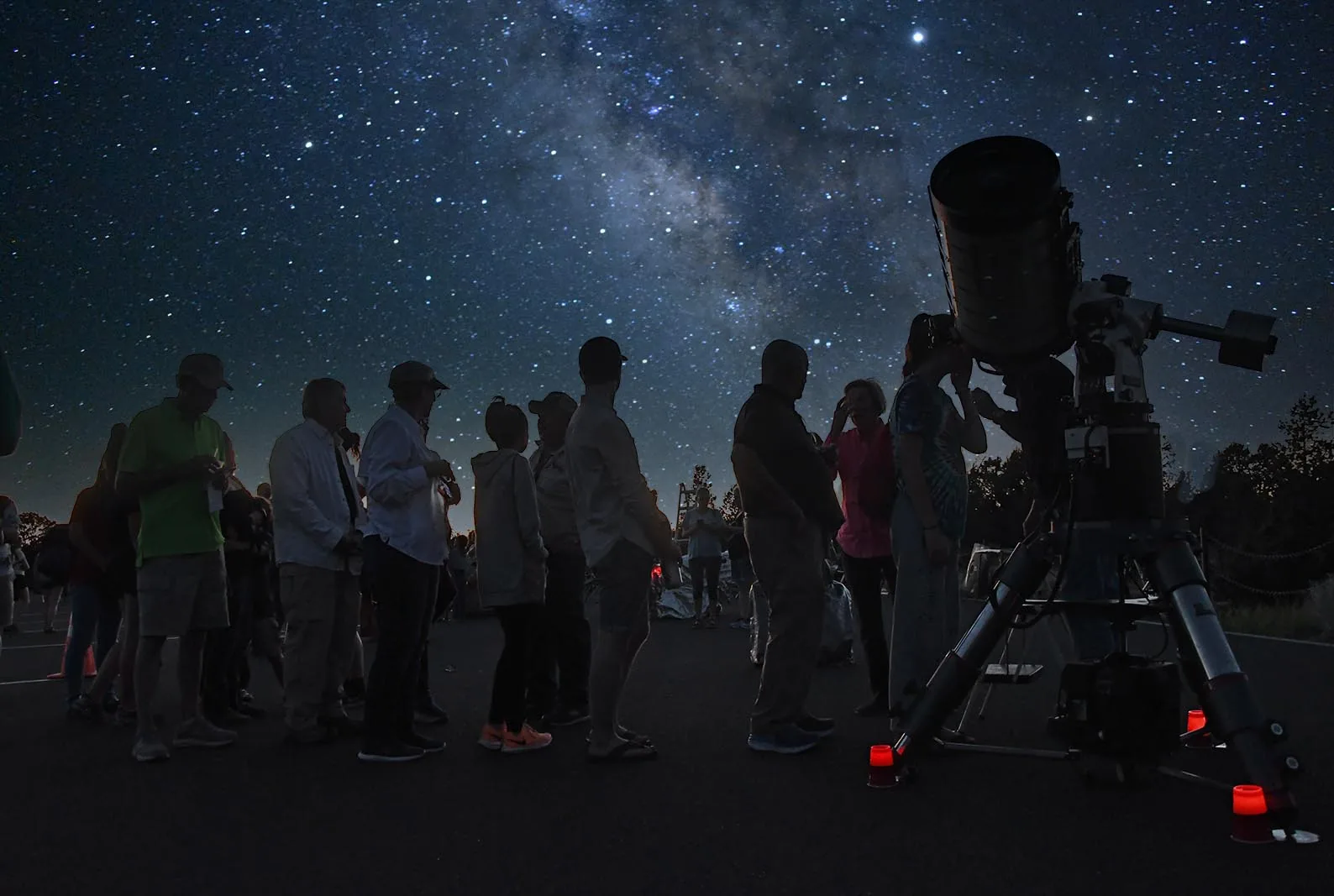 Stargazers gathered beneath a star-filled sky