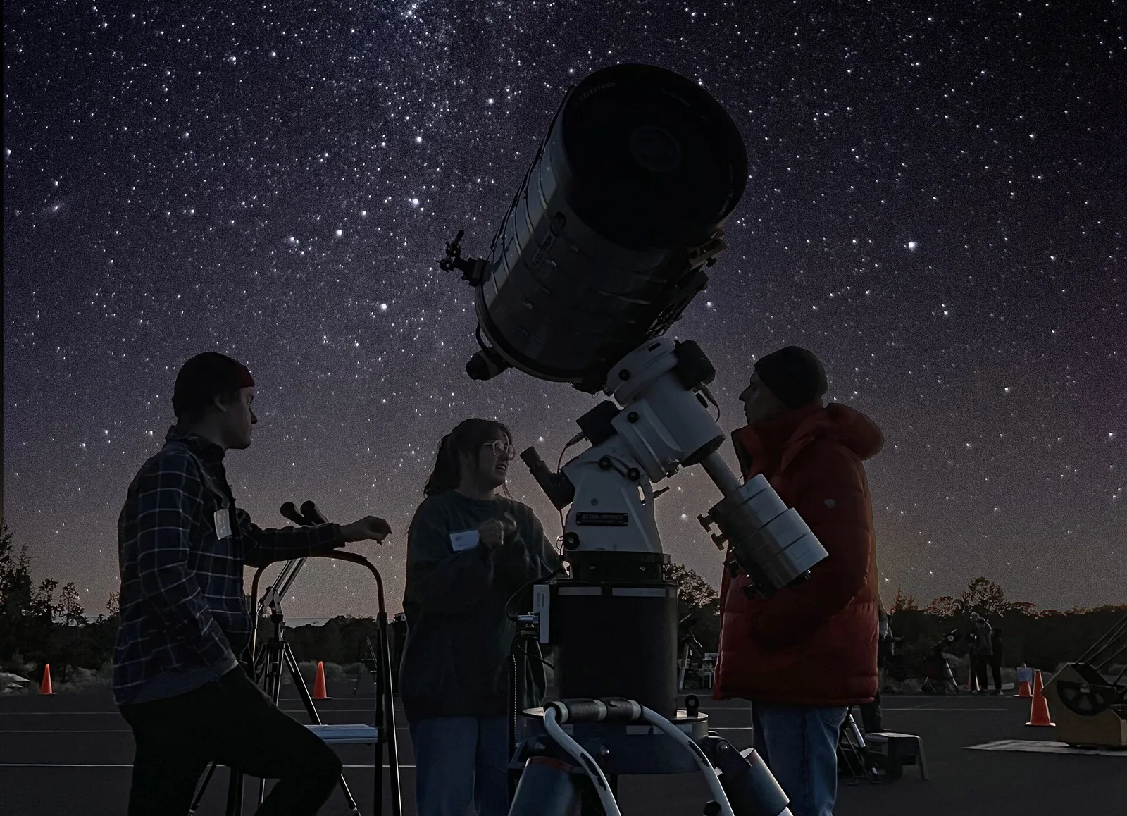 Guests observing the cosmos through a telescope