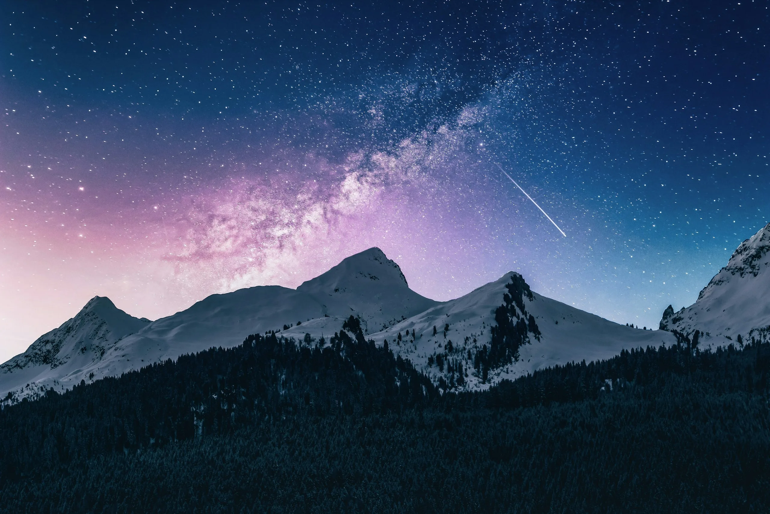 The Milky Way arching over snow peaks