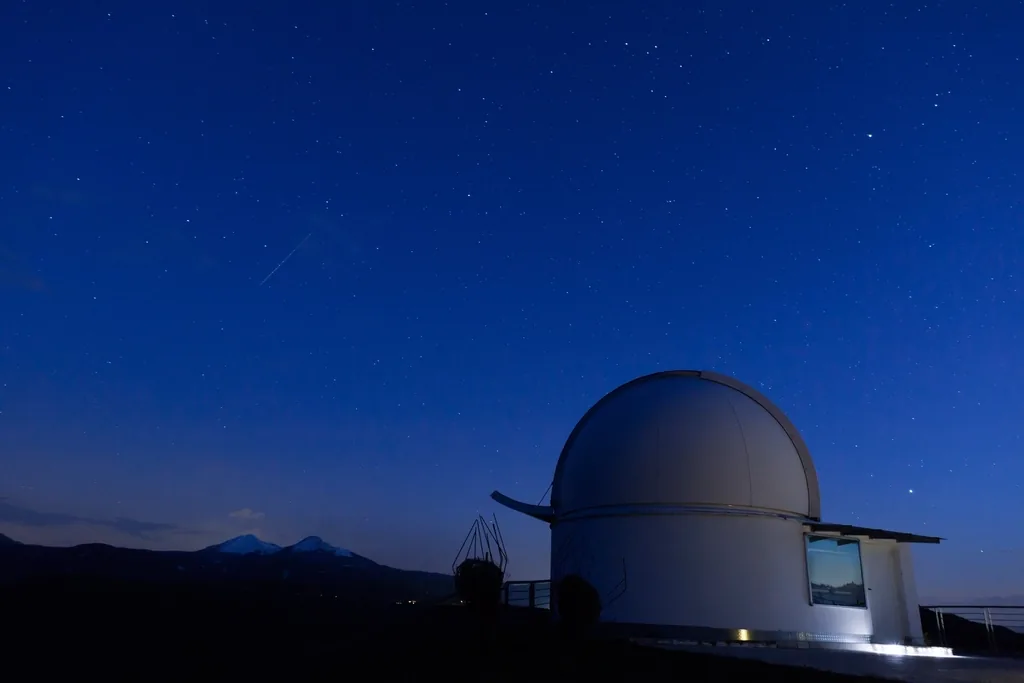 A premium telescope set up under the night sky